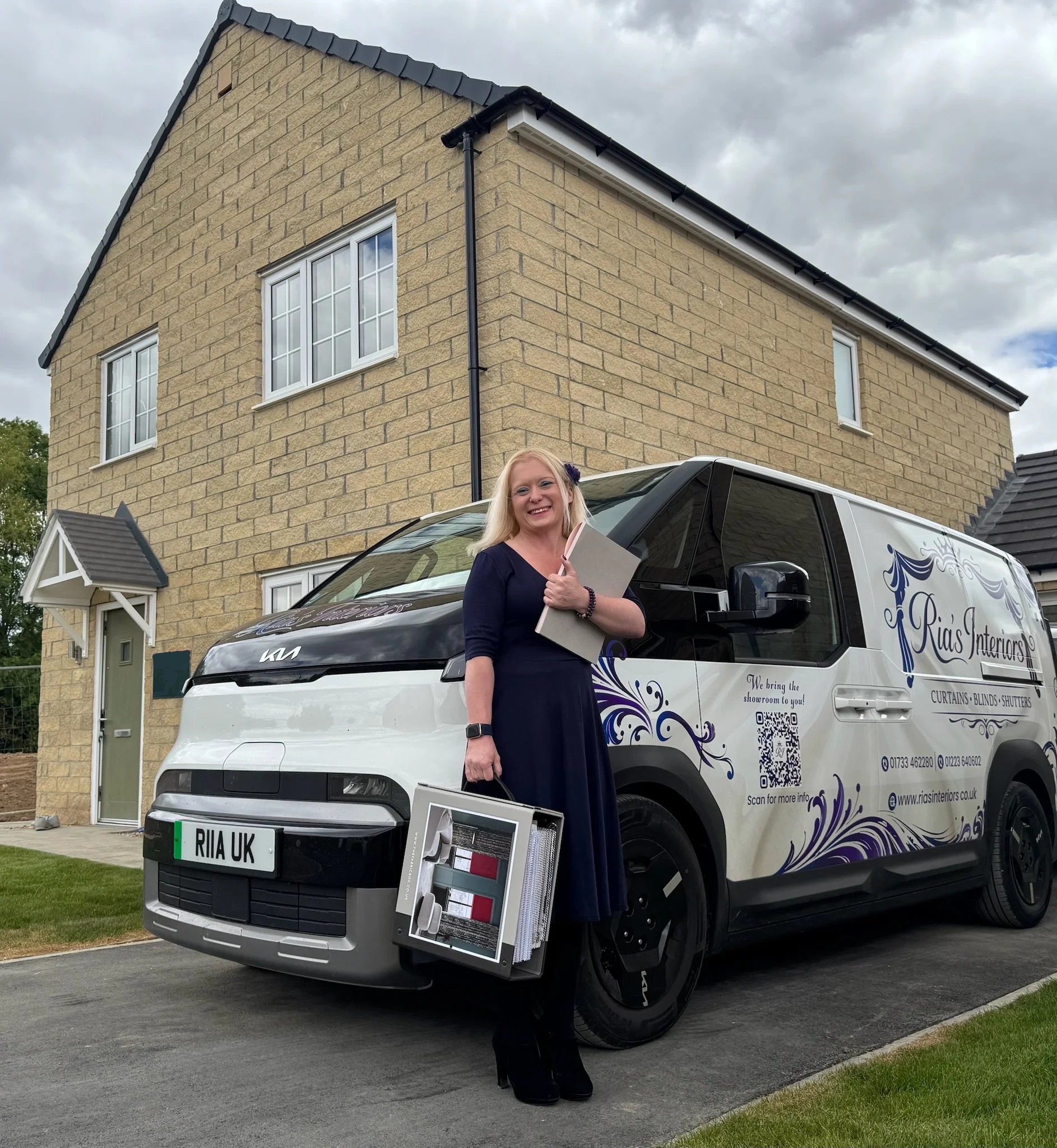 Ria from Ria's Interiors with branded van and samples outside a new build home