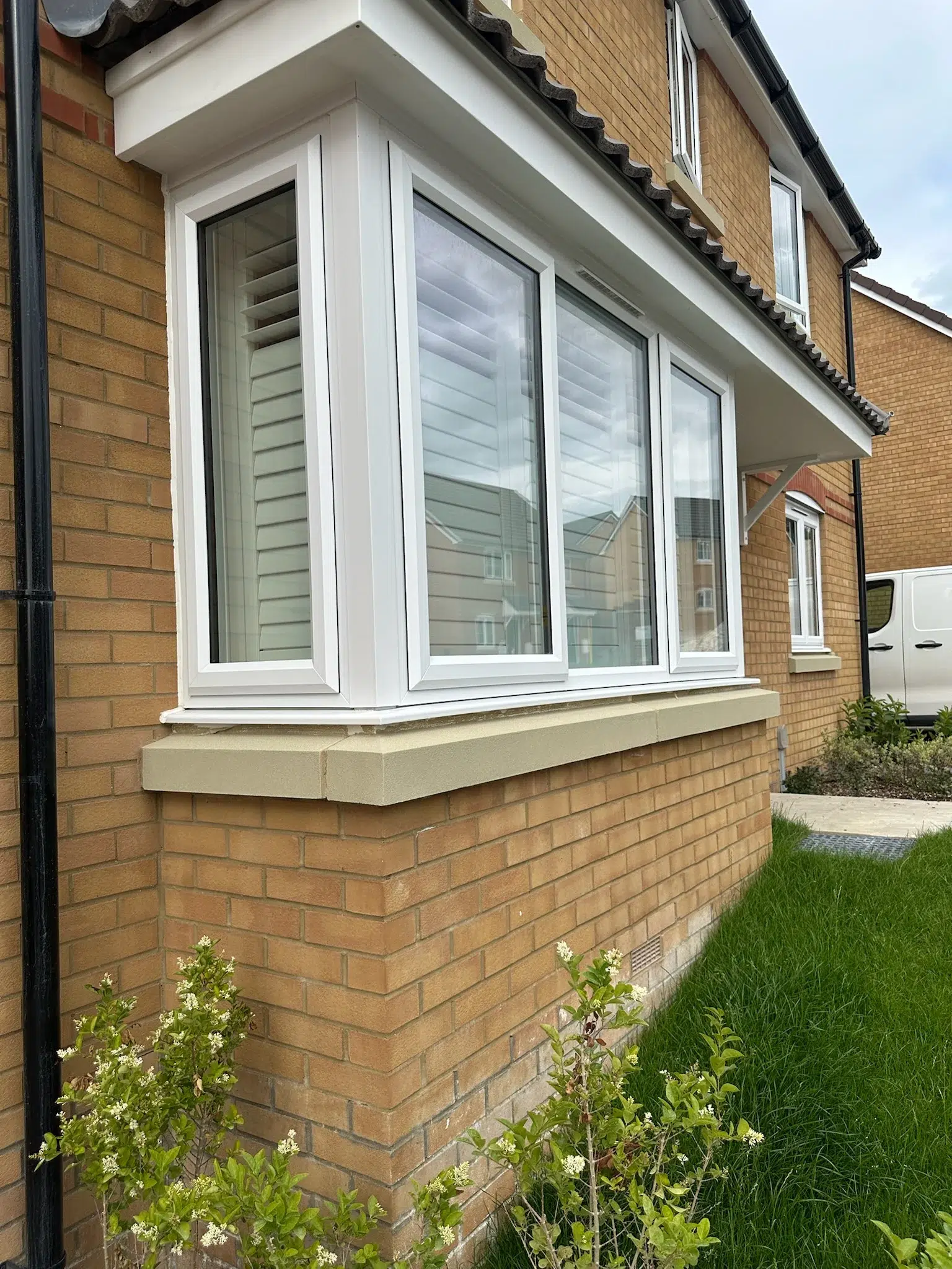 External view of a bay window with fitted shutters inside