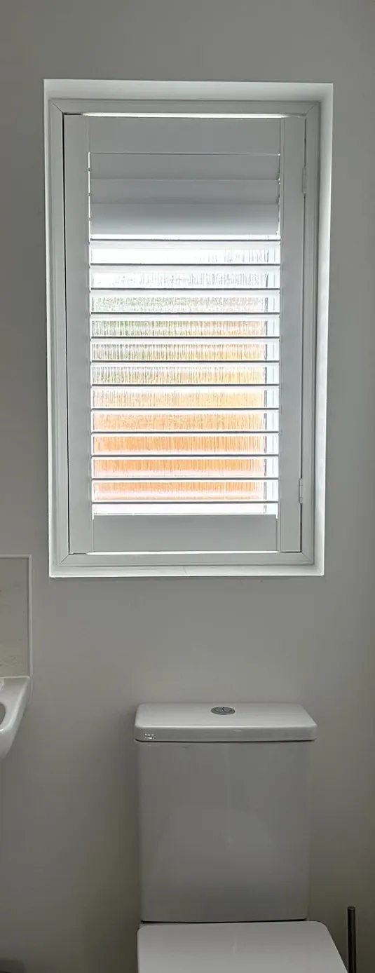 White made-to-measure shutter fitted to a narrow cloakroom window