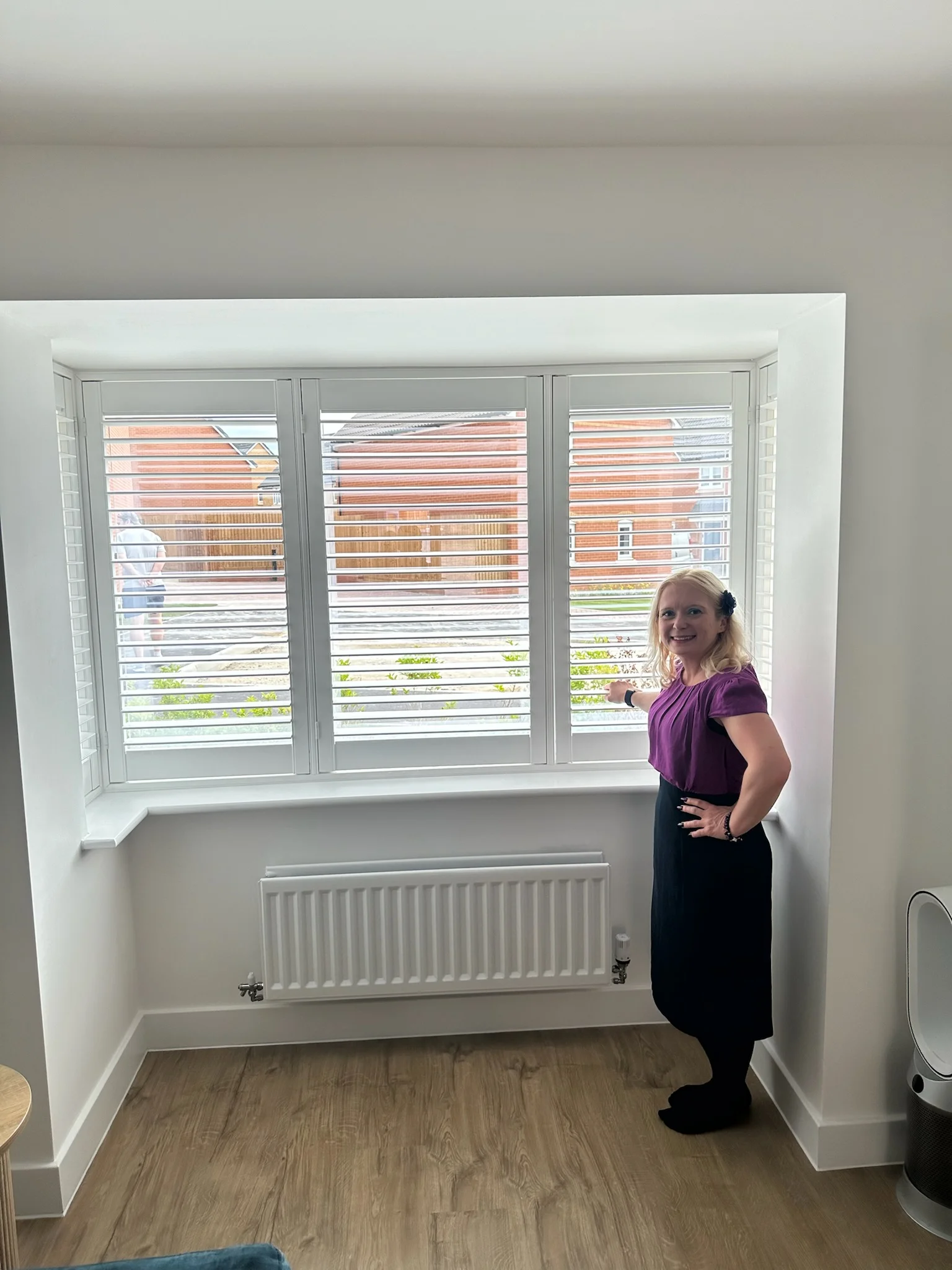 Ria beside a completed shutter installation