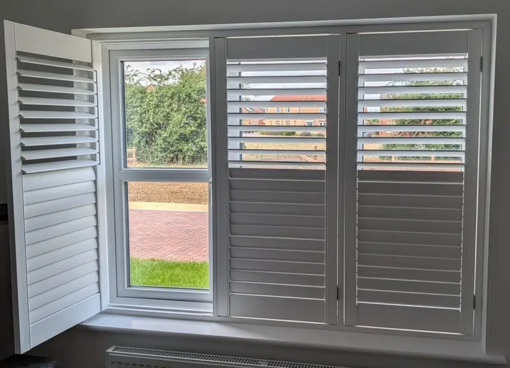 The same window with one shutter panel swung open and the remaining panels closed