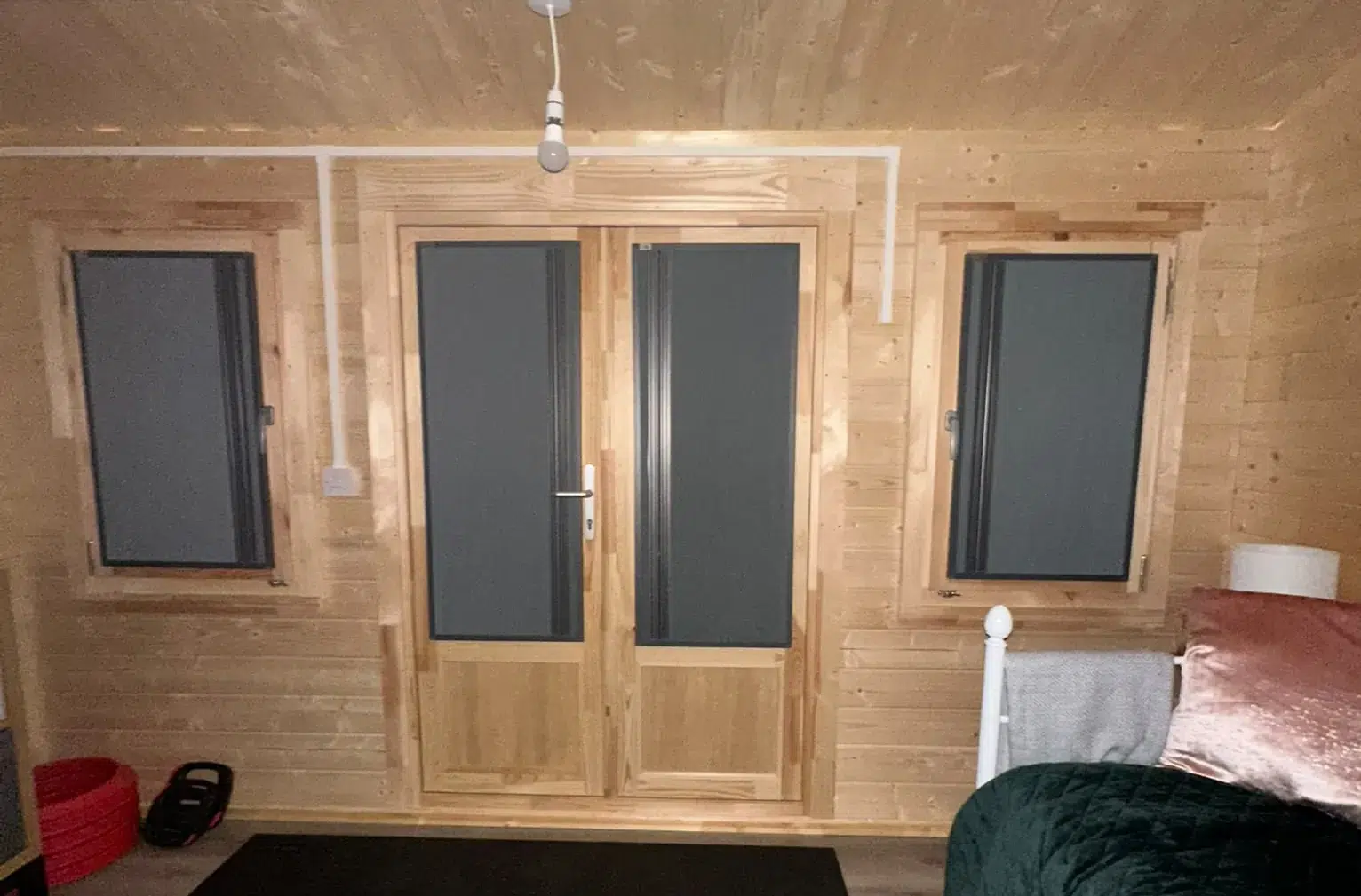 Closed dark BlindScreen blinds fitted inside a timber garden room