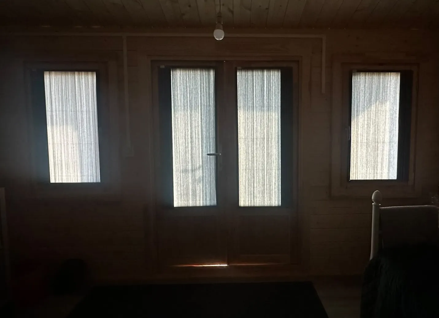 BlindScreen blinds filtering daylight across garden room windows and French doors