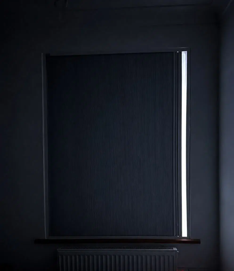 BlindScreen blackout blind lowered, showing real blackout performance in daylight