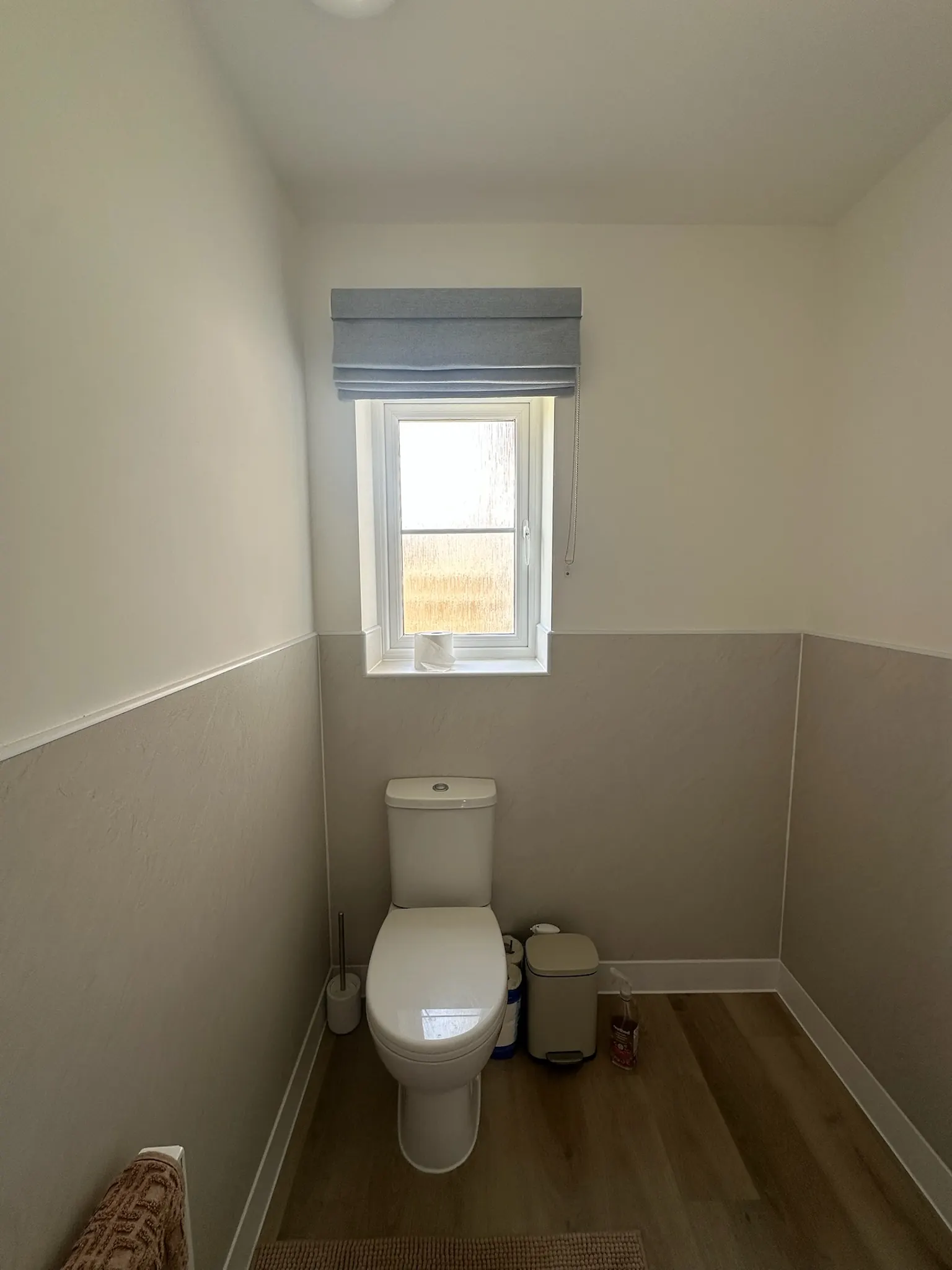 Grey-blue Roman blind fitted above a bathroom window