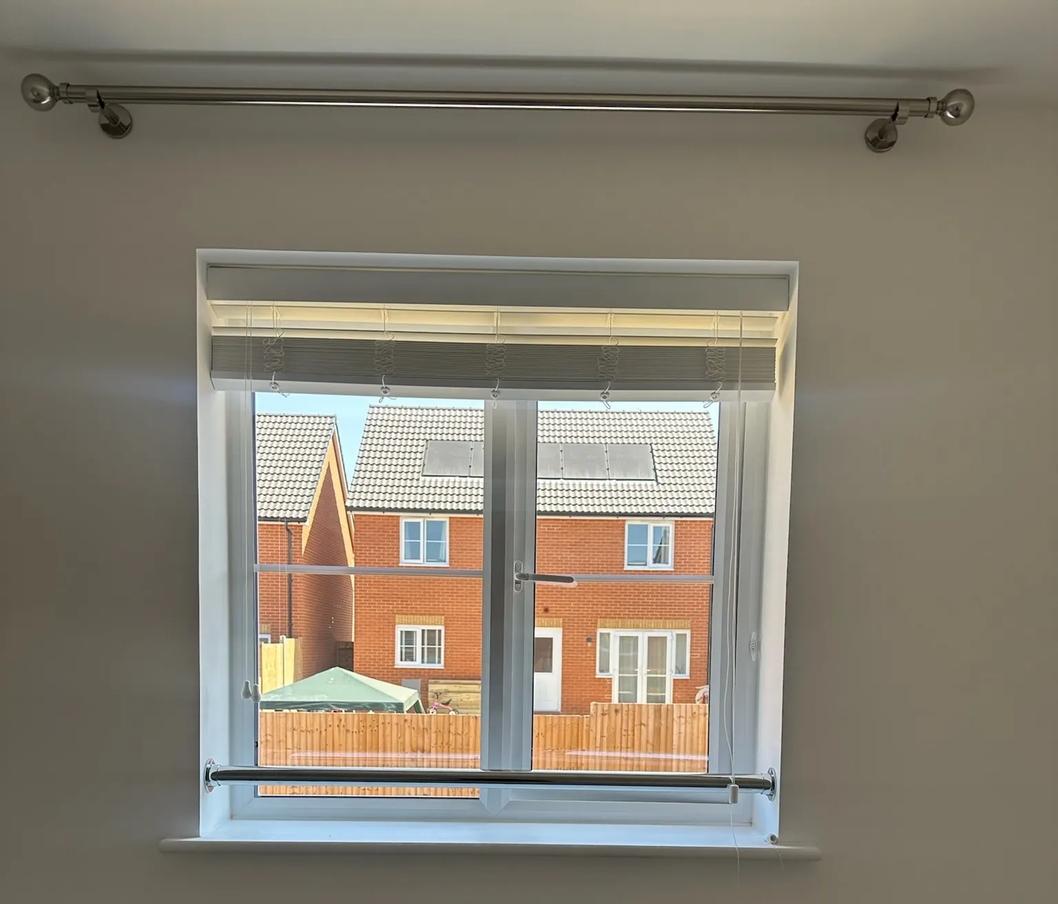 The previous blind raised at the bedroom window before replacement