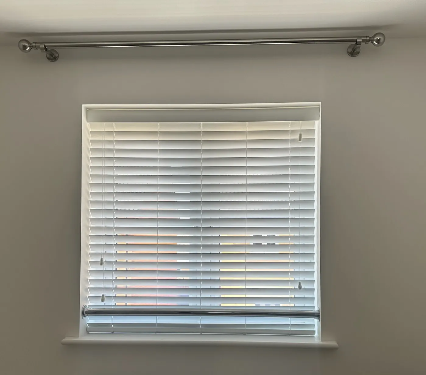 Wood-effect Venetian blinds fitted to the same bedroom window