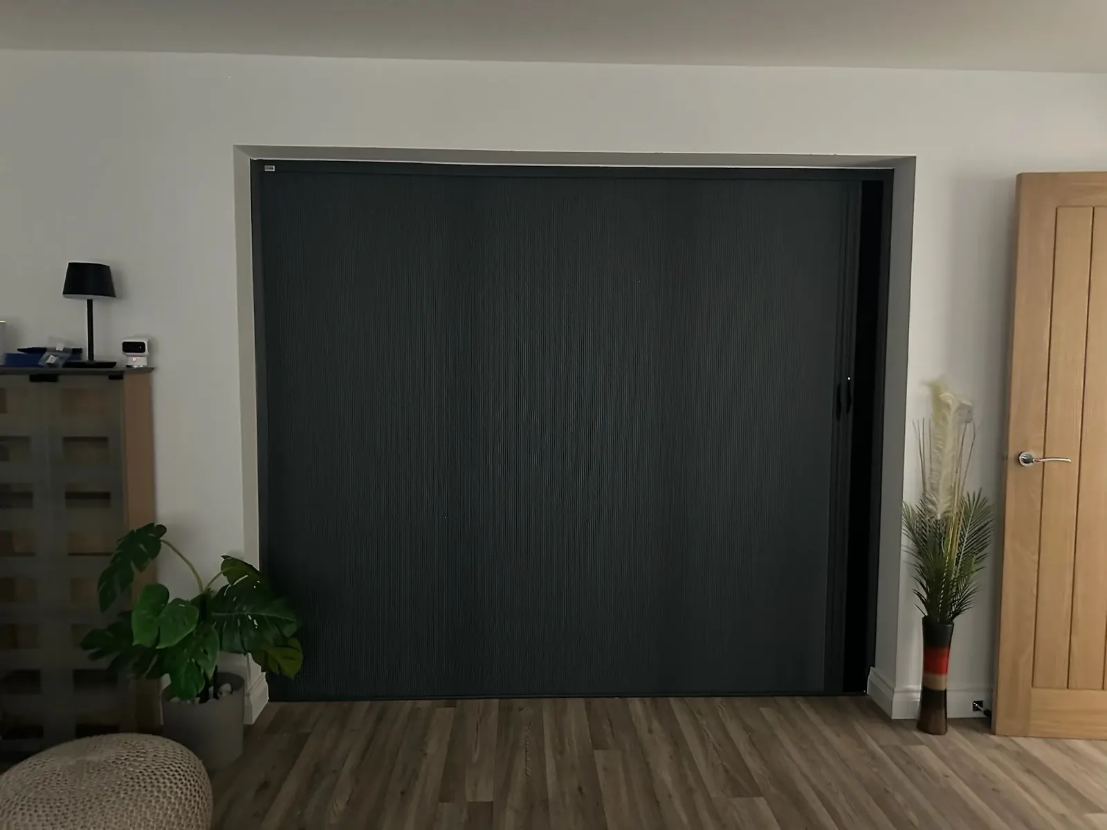 BlindScreen panel fully closed across living room doors for privacy and shade